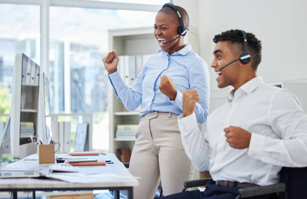 istock People, call center winner and computer for success, winning and telecom achievement, target celebration or sales. Happy agent or consultant teamwork with yes, fist or excited for telemarketing goals 1816627558