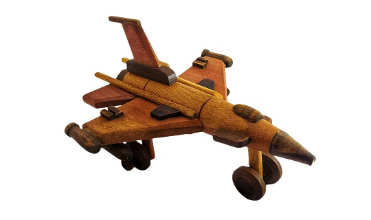wooden military miniature toy airplane. wooden toy on white background. miniature wooden fighter jets on white background