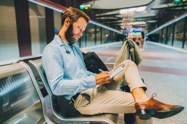 istock Businessman on business trip using tablet 1816630789