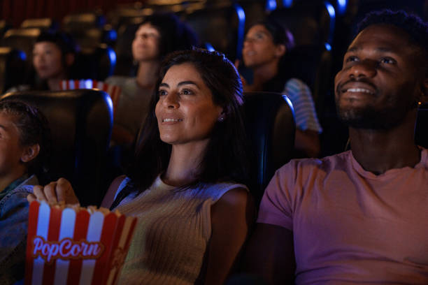 istock Young couple watching a film inside movie theater 1816634023