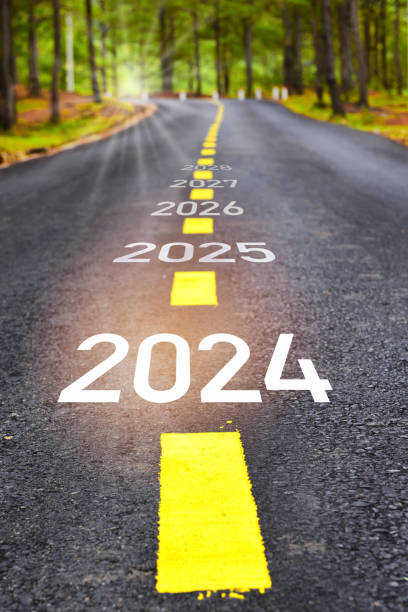 2024 to 2028 sustainable future lifestyle on road in the forest stock photo