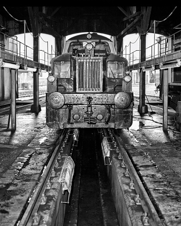 A locomotive undergoing maintanance. Film scan.