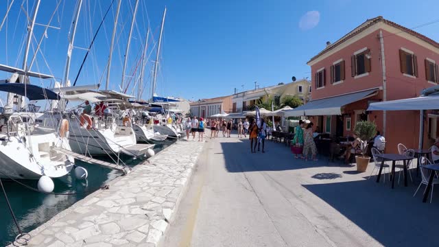 Pov motion lapse on promenade streets of Gaios town on Paxos island in Greece crowded with tourist visitors during summer vacation