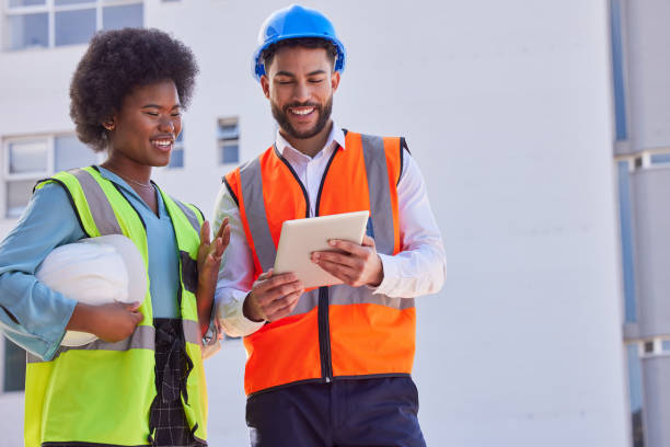 istock Engineering, tablet and teamwork with people on construction site for inspection, planning or project management. Architecture, buildings and designer with man and black woman in city for development 1816680096