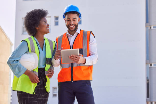 istock Architecture, tablet and teamwork with people on construction site for inspection, planning or project management. Engineering, buildings and designer with happy man and black woman for development 1816680101
