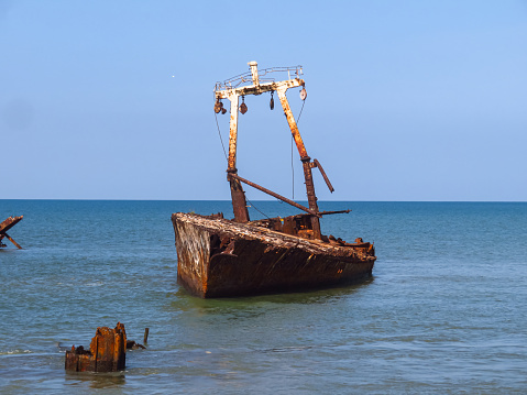 Abandoned ship on the shipwreck beach (Ship Cemetery, Cemitério de Navios) in Panguila, Luanda Province in Angola.