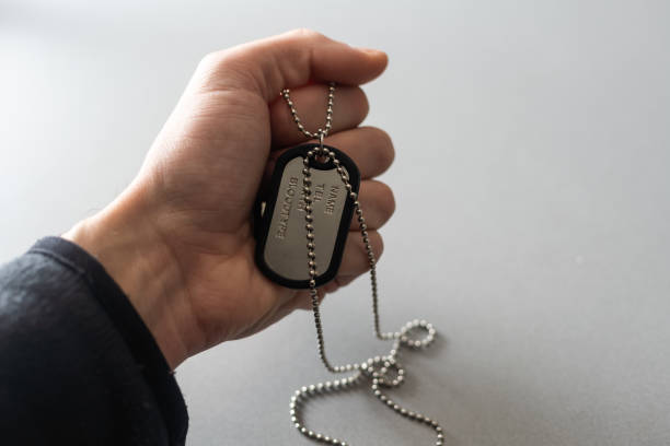 istock Man holding military ID tag on white background, closeup 1816683981