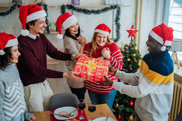 istock Friends exchanging gifts on New Year 1816702228