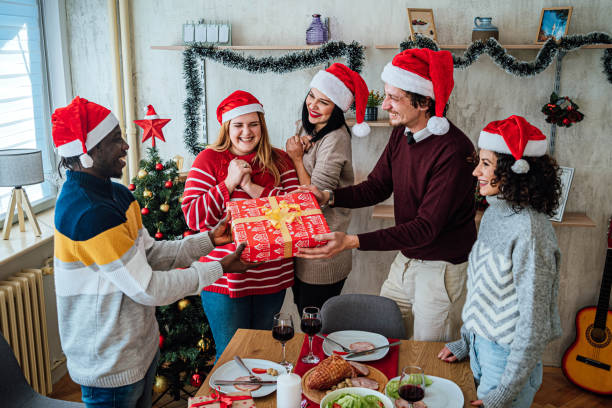 istock Friends exchanging gifts on New Year 1816704362