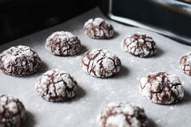 istock Chocolate cookies with powdered sugar on baking tray. Close-up. 1816717290