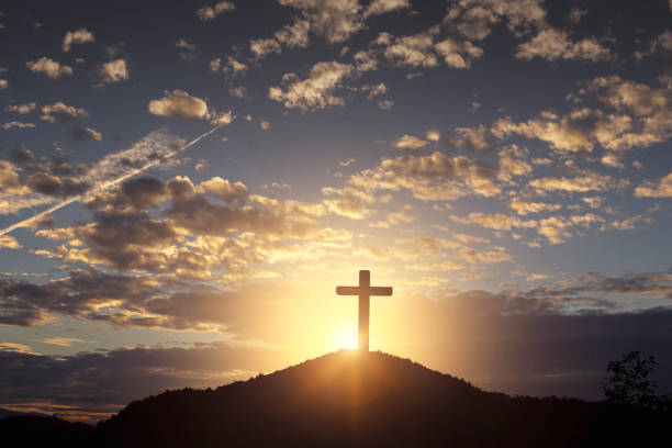istock Silhouette wooden cross on mountain sunset background 1816719507