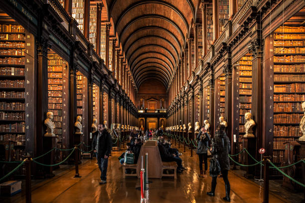 A Vast Collection of Books Adorns the Shelves of an Elegant Library Dublin, Ireland - November 1, 2016: The Library of Trinity College trinity college library stock pictures, royalty-free photos & images