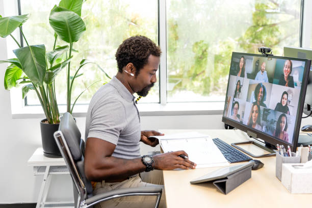 istock Businessman reviews notes during video conference with diverse co-workers 1816744461