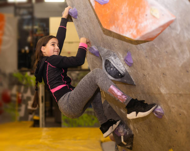 istock teenager climbing a rock wall 1816747195