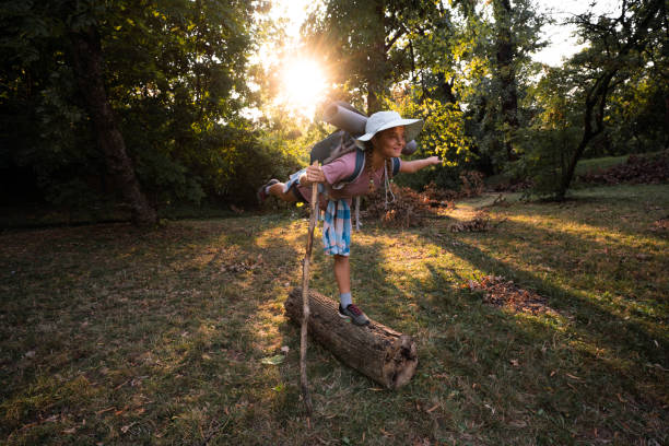 istock A girl balances on a tree trunk in the forest 1816766671