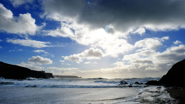 Stormy sky and sea at Church Cove, Gunwalloe on the Lizard Peninsula, Cornwall, UK