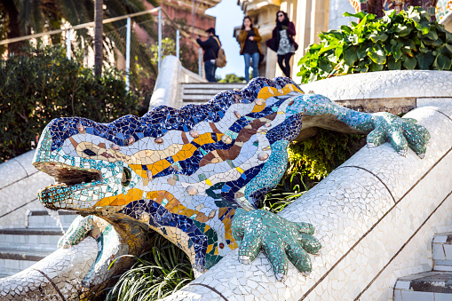 Barcelona, Spain - January 23, 2015: Park Güell. Designed by architect Antoni Gaudí, this UNESCO World Heritage Site is a captivating blend of vibrant mosaic sculptures, curving architectural elements, and lush gardens. Visitors can stroll through the surreal landscape, enjoying panoramic views of Barcelona and marveling at the artistic brilliance that defines this iconic public park.