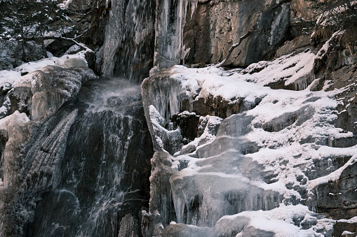 Frozen waterfall in winter mountain gorge