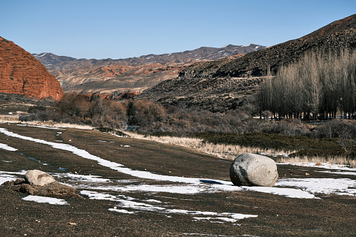 Mountain view with lonely stone in late autumn mountain gorge in Central Asia