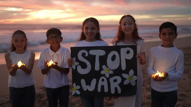 Portrait of child friends protesting against the war on the beach