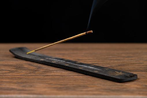 Smoke coming from an extinguished wood match. Black background ... Copy space. 