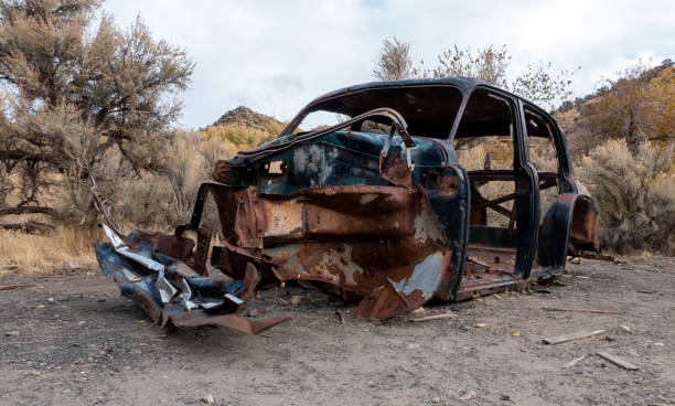 Old mangled car and abandoned 1930s car on the Utah desert.