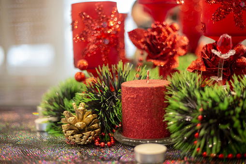 christmas burning candle over on decorative candlestick