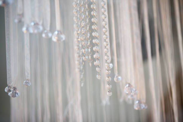 Crystal clear pendants as decoration for holiday decoration. Lots of hanging ribbons with rhinestones like a curtain.