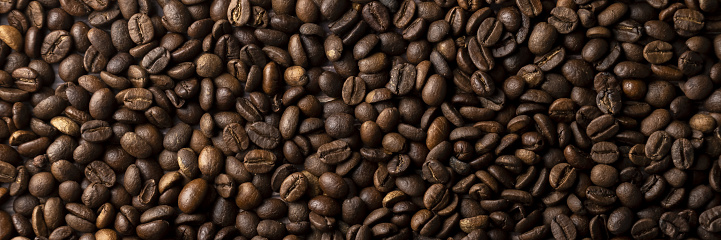 Roasted coffee beans background. Healthy beverage ingredients