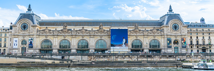 Exterior of the Orsay museum building on the quay of the Seine river in Paris, France