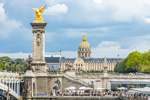 Pont Alexandre III bridge and the Seine in Paris France with Hotel des Invalides in the background