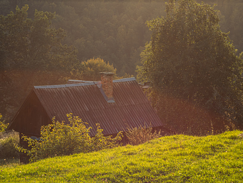 Old authentic wooden house with hayloft in scenic Carpathian mountains Ukraine, Europe, Transcarpathia region. Local countryside travel forest hiking trails. Cottagecore style vacation. Eco tourism