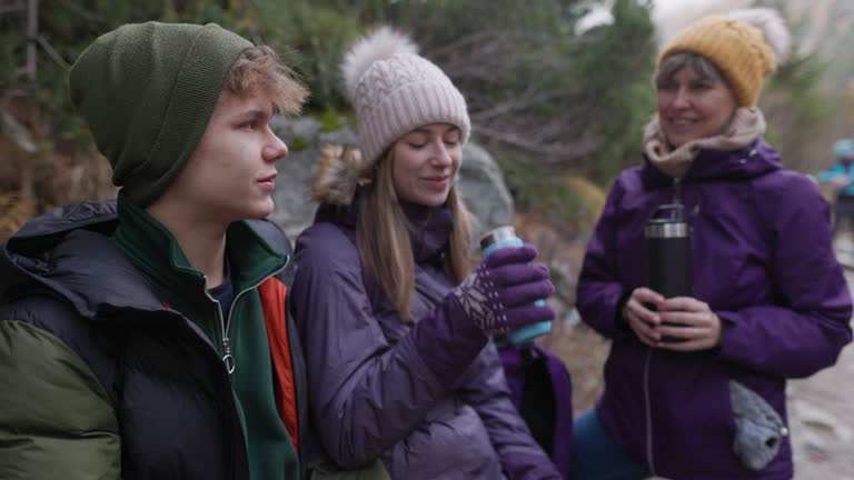 Family drinking hot tea in the High Tatra Mountains, Slovakia on an autumn day