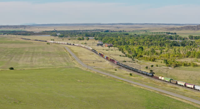 Retreating Ascending Aerial Shot of Moving Train in Greycliff, Sweet Grass County, Montana