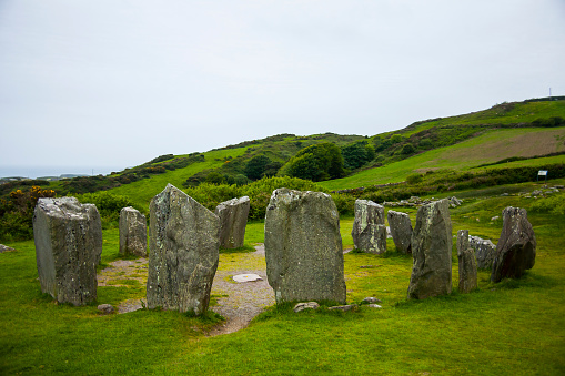 Drombeg stone circle, also known as the Druid's Altar, is a prehistoric site located in County Cork, Ireland. It is a megalithic stone circle that dates back to the Bronze Age, around 2000-1400 BCE. The circle consists of 17 closely spaced standing stones, with a flat recumbent stone at the center.  Ireland