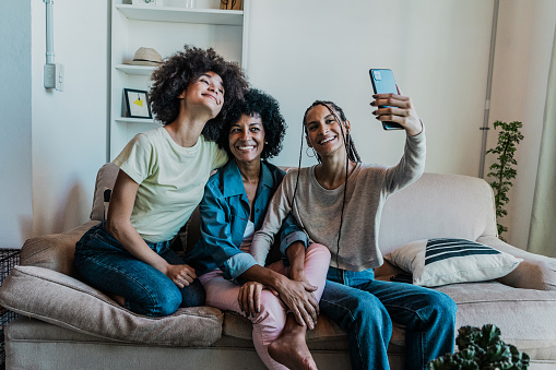 Family together taking a selfie in the living room at home