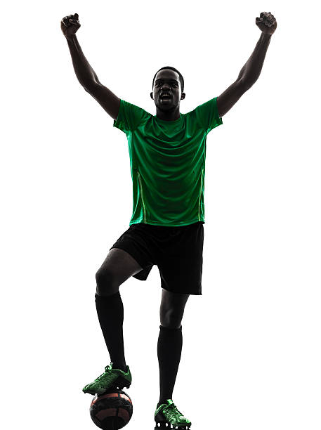 istock african man soccer player celebrating victory silhouette 181688895