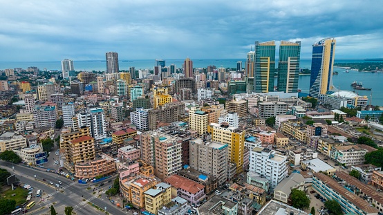 This aerial view showcases the bustling city from the viewpoint of a tall building in the center