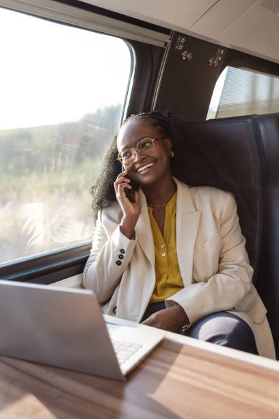 istock A young African American female freelancer talking on her phone, while enjoying her train ride on a sunny day 1816902014