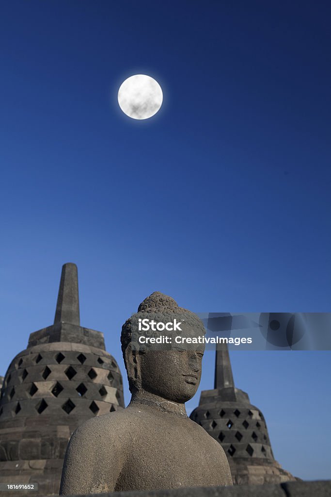 Statue and stupa at borobudur 1 Shot of statue and stupa at borobudur temple, Yogyakarta, Java, Indonesia. Ancient Stock Photo