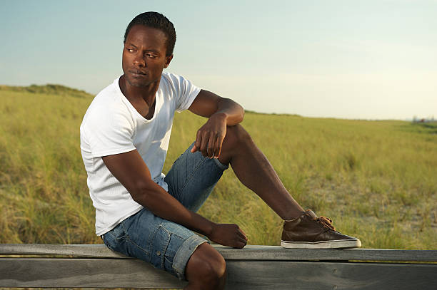 istock Portrait of a handsome young man sitting alone outside 181693881