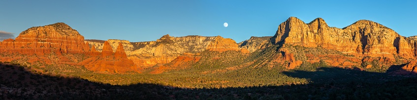This is a photograph of a dirt hiking trail leading to a mountain landscape outside Sedona, Arizona in spring time.