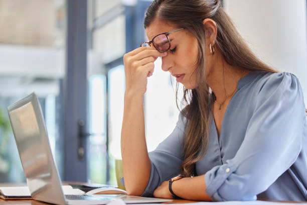 istock Stress, problem and business woman with headache, anxiety or workload pressure in office. Burnout, pain and financial advisor suffering migraine, ache or anxious while checking tax documents deadline 1816947034