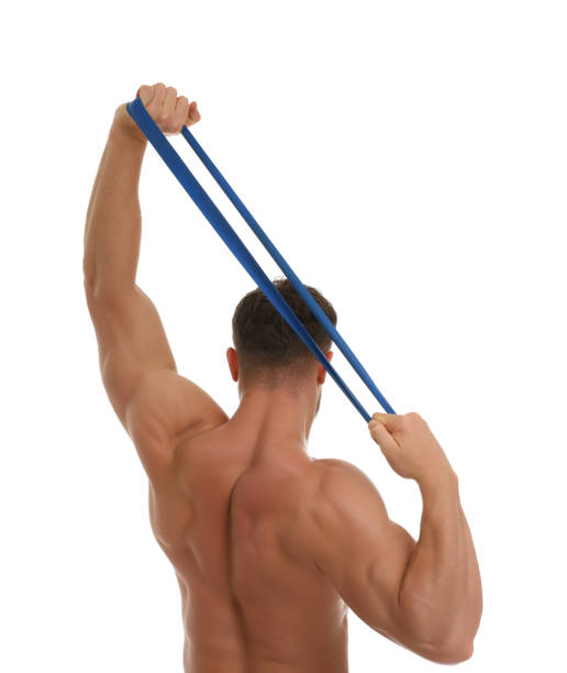 istock Young man exercising with elastic resistance band on white background, back view 1816947545
