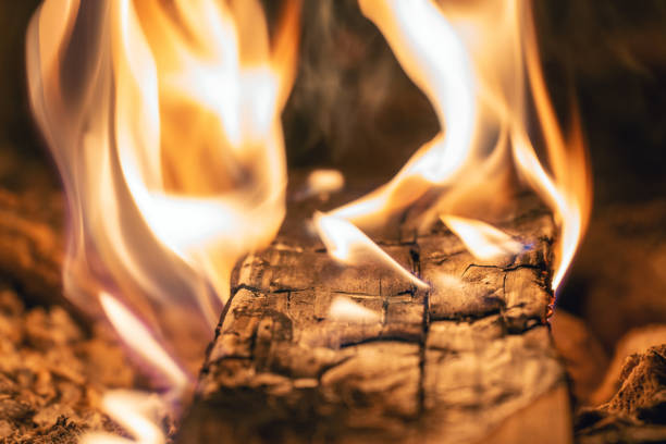 Bright flame of a burning fire in the dark.