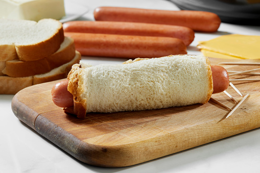 Preparing Crispy Air Fried Grilled Cheese Hot dog Rolls. Made with Processed cheese slices and flattened White Bread