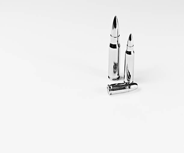 Silver Bullets 1 9mm lying flat, 7.62mm and 9mm silver bullets standing up on a white background Silver Bullet stock pictures, royalty-free photos & images