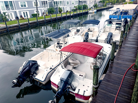 Close up high angle view of boats moored to a dock in canal in Sarasota, Florida