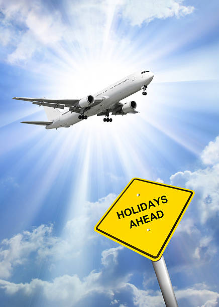 istock Airplane flying against clouds and sunburst 181696742