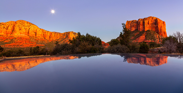 Two adults riding bicycles along a road in Zion National Park. Two women on a relaxing bike ride enjoy the scenery of Zion, in Utah